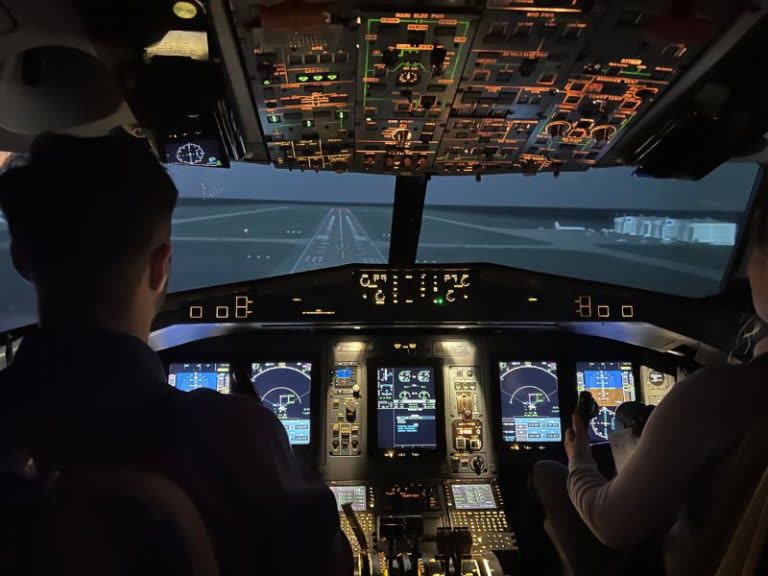 Boeing flight simulator cockpit interior with pilots during flight training