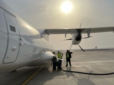 Ground crew refuelling the ATR 72-500 freighter at sunset