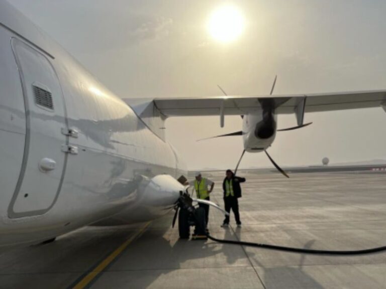 Ground crew refuelling the ATR 72-500 freighter at sunset